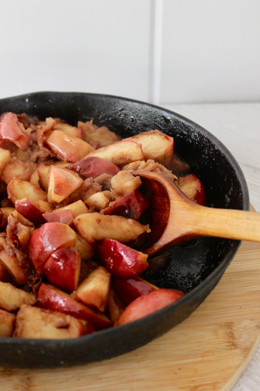 Close-up of fried apples in an iron skillet