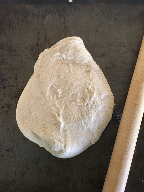 Ball of bread dough on a baking sheet