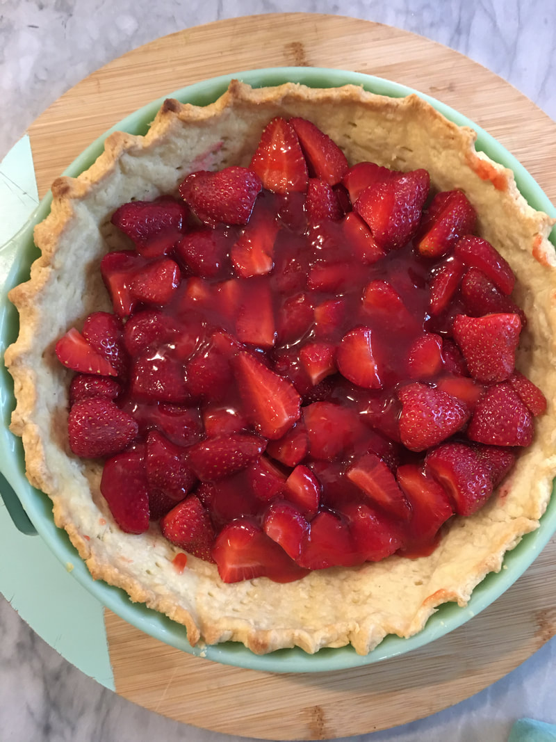 Pie crust with half of the berries and half of the strawberry glaze.