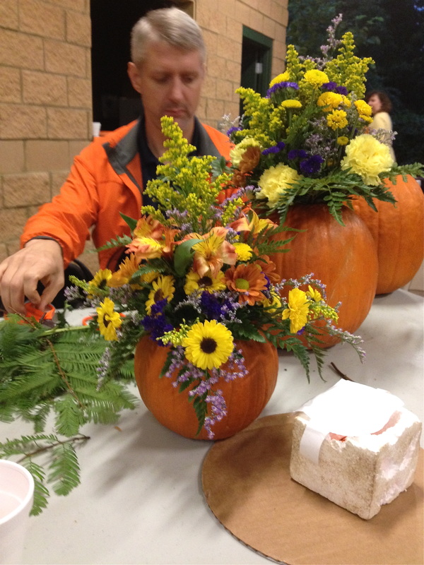 My husband making a pumpkin floral arrangement