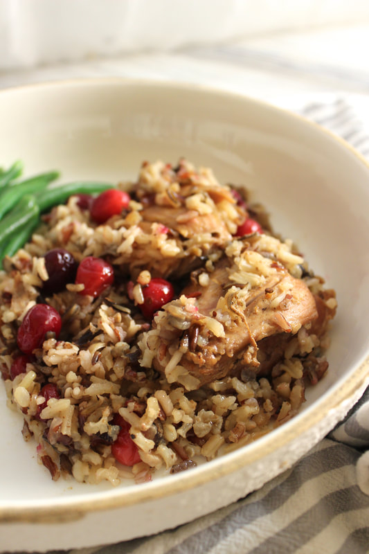 Close up view of slow cooker chicken with wild rice and cranberries