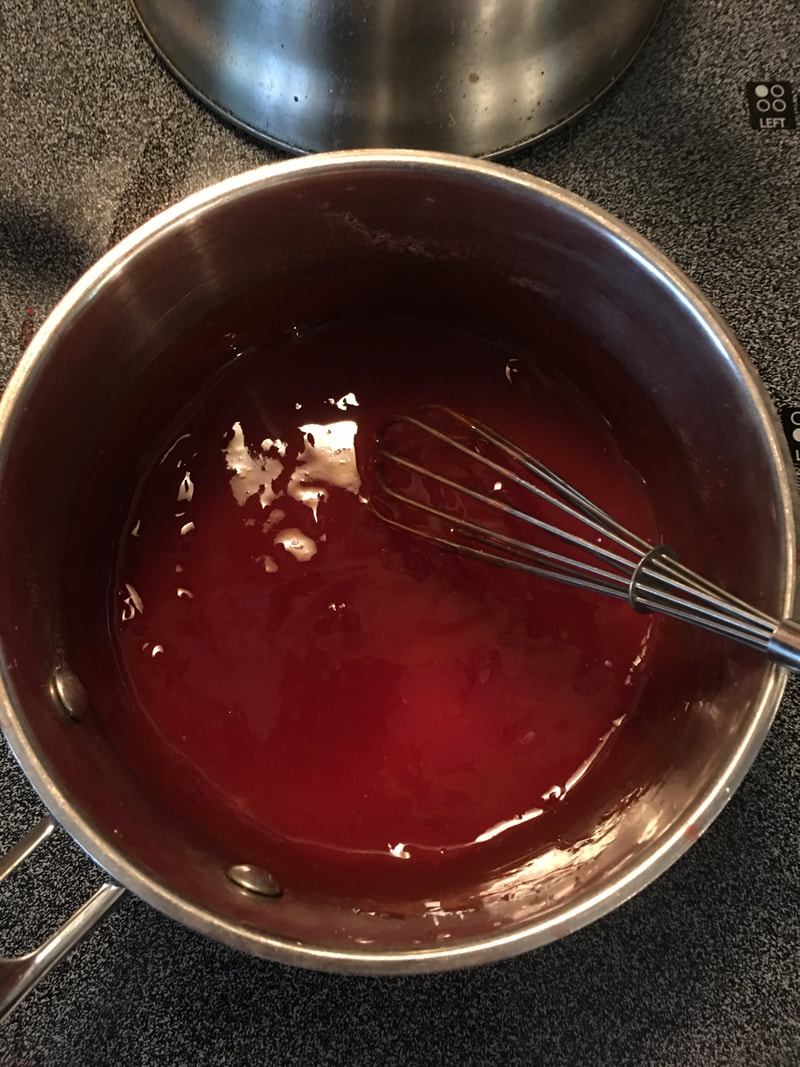 Homemade strawberry pie glaze that has cooked and thickened