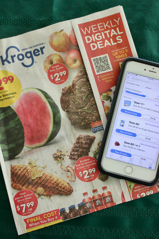Kroger Ad with my phone displaying Kroger e-coupons