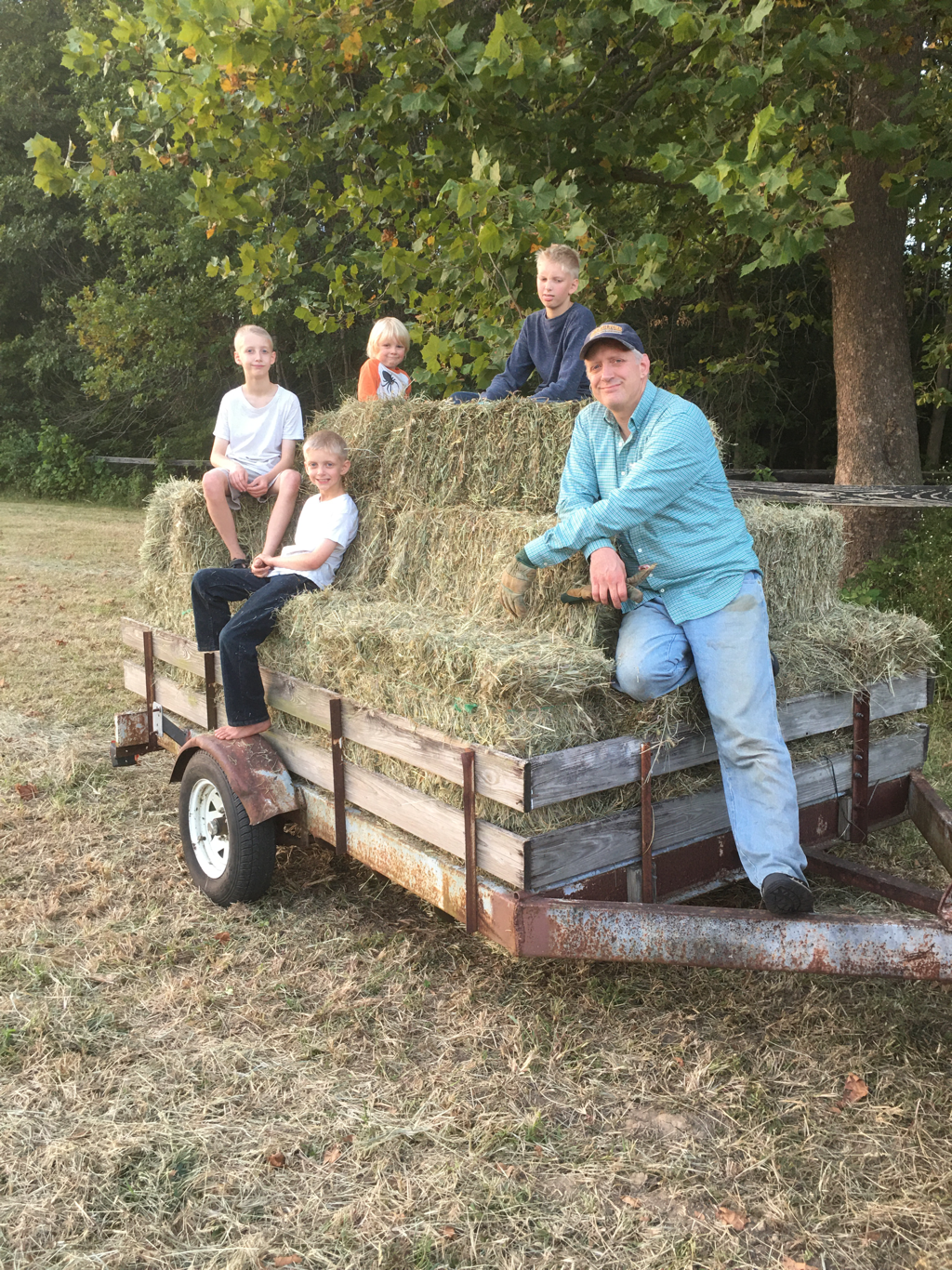 Steve and the boys posing on the hay wagon.